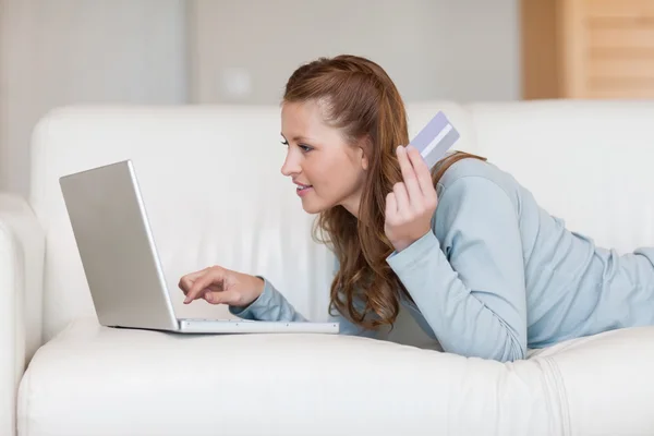 Comprador online feminino em seu sofá — Fotografia de Stock