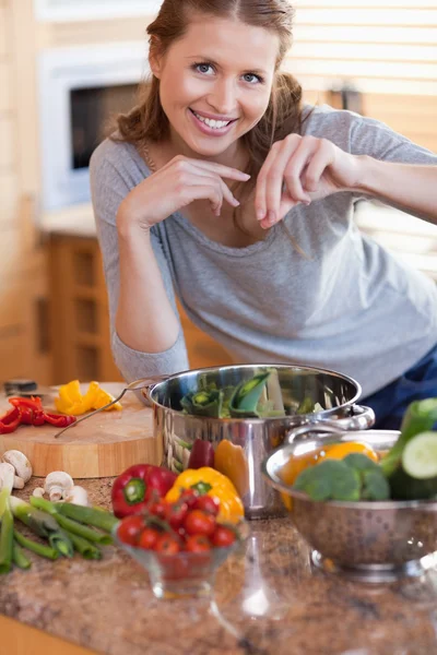 Woman adding some spices to her meal — Stock Photo, Image