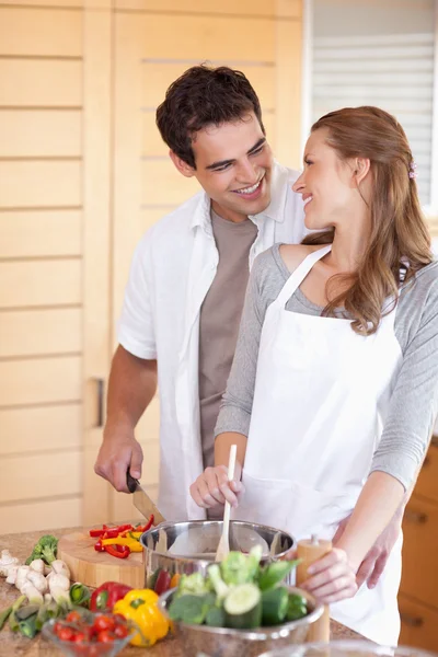 Man helping his girlfriend cooking — Stock Photo, Image