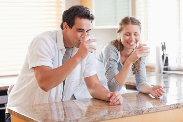 Couple drinking milk in the kitchen — Stock Photo, Image