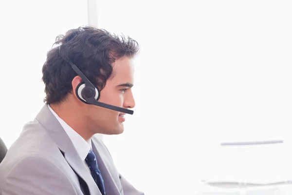 Side view of businessman with headset on — Stock Photo, Image