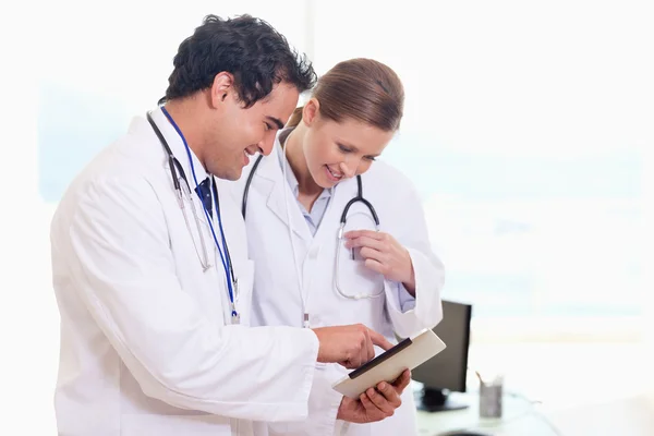 Assistenti medici guardando clip board — Foto Stock