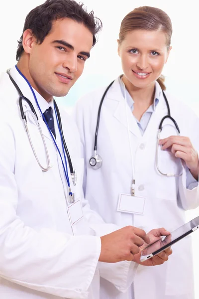 Médicos assistentes com tablet — Fotografia de Stock