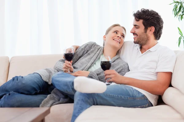 Νεαρό ζευγάρι που έχοντας ένα ποτήρι κόκκινο κρασί — Φωτογραφία Αρχείου