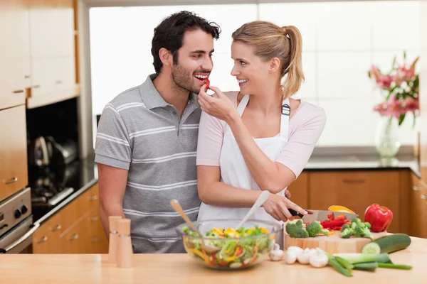 Lovely couple slicing pepper — Stock Photo, Image