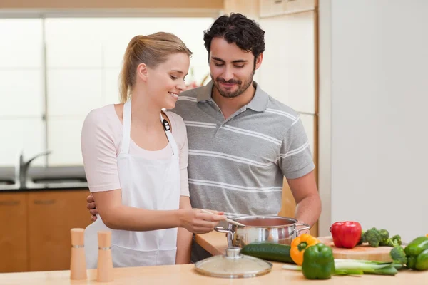 Lovely couple preparing a sauce — Stock Photo, Image