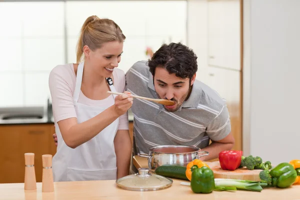 Charming couple preparing a sauce — Stock Photo, Image