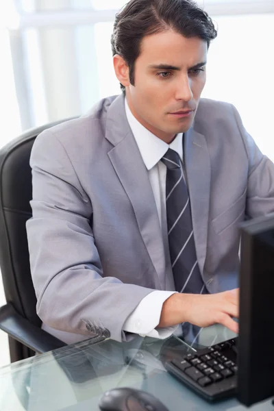 Porträtt av en fokuserad affärsman som arbetar med en dator — Stockfoto