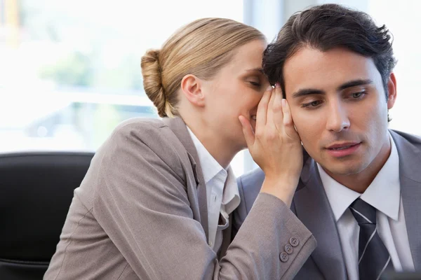 Businesswoman whispering something to her colleague — Stock Photo, Image
