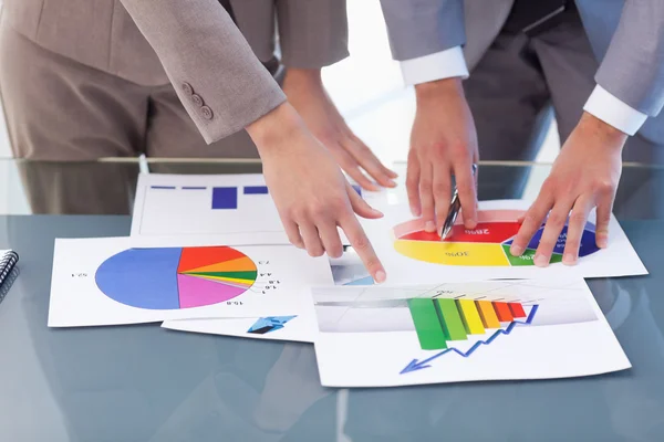 Hands of business studying statistics — Stock Photo, Image