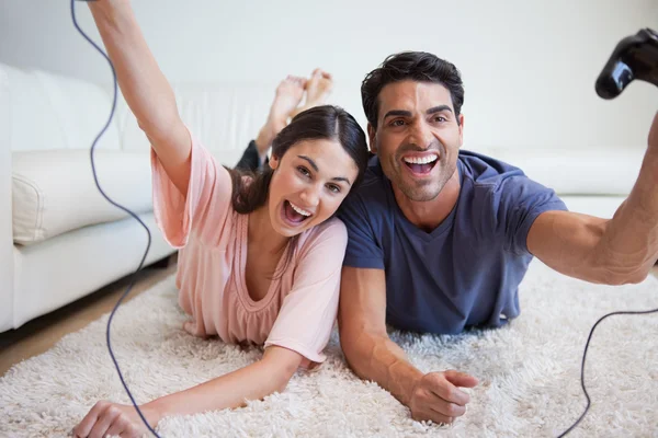 Riendo joven pareja jugando videojuegos — Foto de Stock