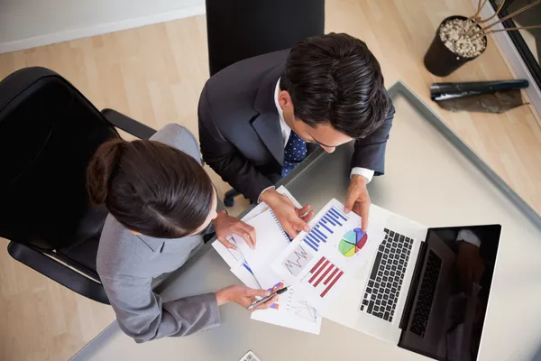 Young sales persons studying statistics — Stock Photo, Image