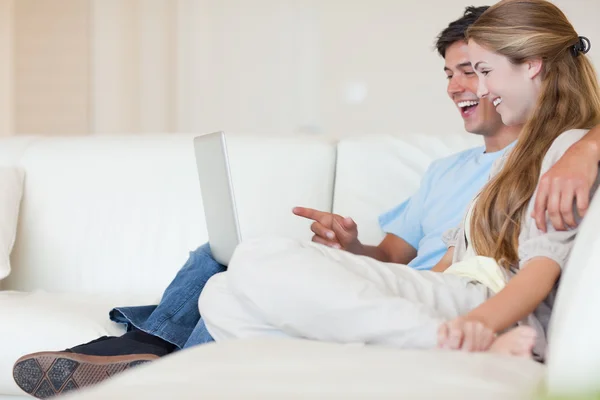 Casal feliz usando um laptop — Fotografia de Stock