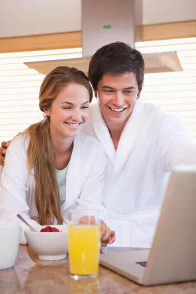 Porträtt av ett par att ha frukost medan du använder en bärbar dator — Stockfoto