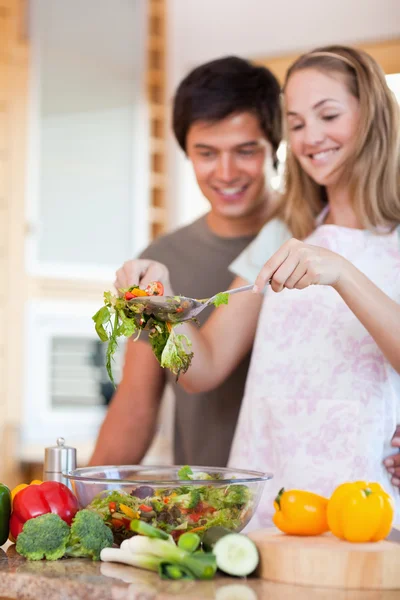 Portrait of a young couple making a salad — Stock Photo, Image