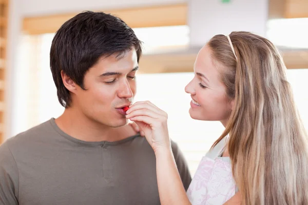 Man tasting the meal of her fiance — Stock Photo, Image