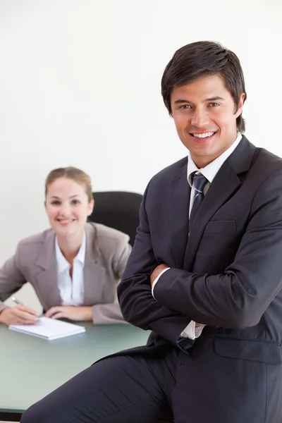 Portrait of a businessman posing while his colleague is working — Stock Photo, Image
