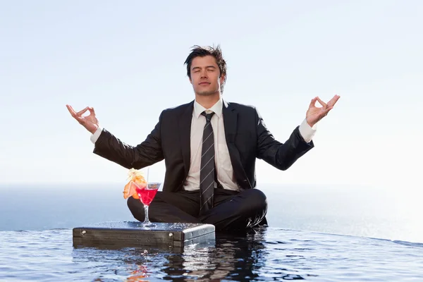 Businessman relaxing in the lotus position — Stock Photo, Image