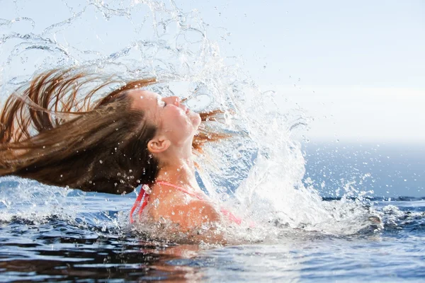 Beautiful woman raising her head out of the water — Stock Photo, Image