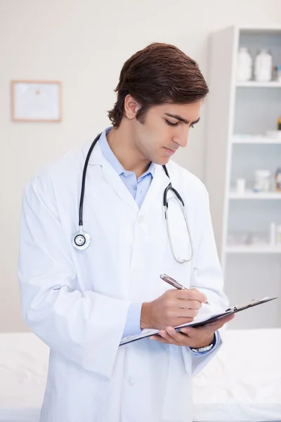 Male doctor taking notes — Stock Photo, Image