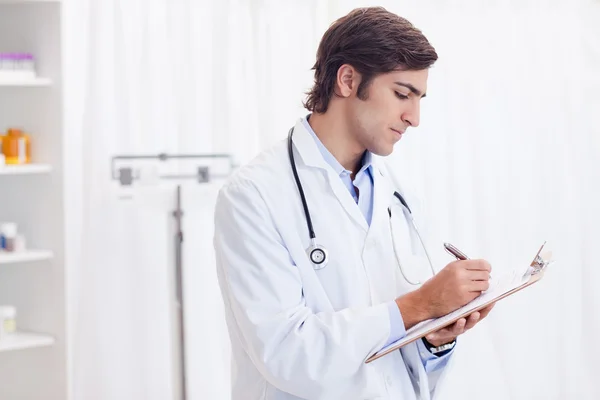 Side view of doctor taking notes — Stock Photo, Image