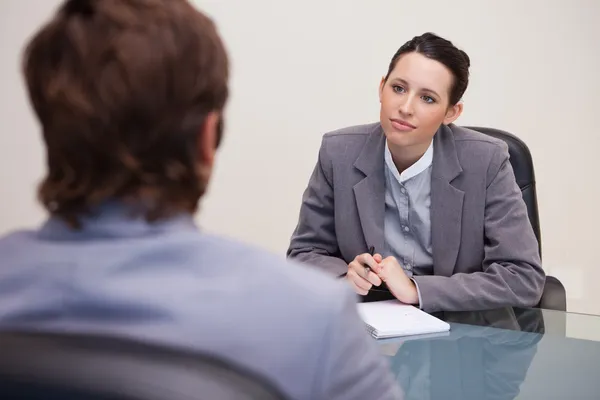 Businesswoman listening to her business partner — Stock Photo, Image
