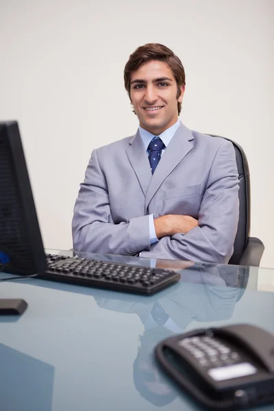 Businessman with folded arms leaning back satisfied — Stock Photo, Image