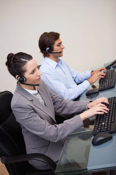 Side view of call center agents at work — Stock Photo, Image