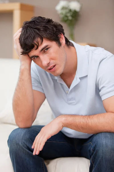 Despaired man sitting on the couch — Stock Photo, Image