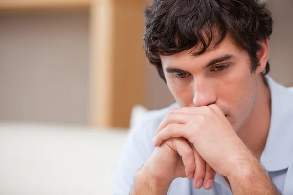 Thoughtful man in the living room — Stock Photo, Image