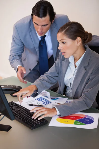 Business working on statistics together — Stock Photo, Image