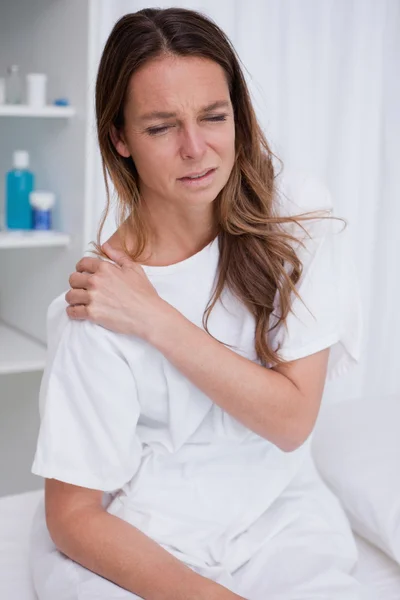 Woman covering painful spot — Stock Photo, Image