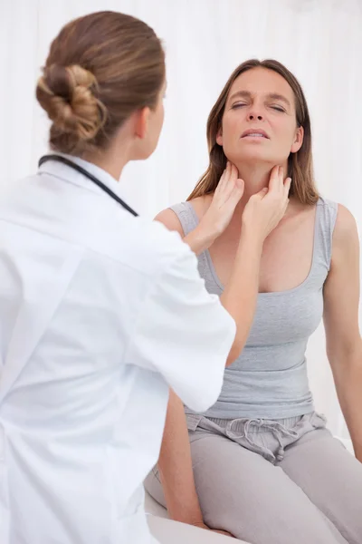 Doctor examining patients throat — Stock Photo, Image
