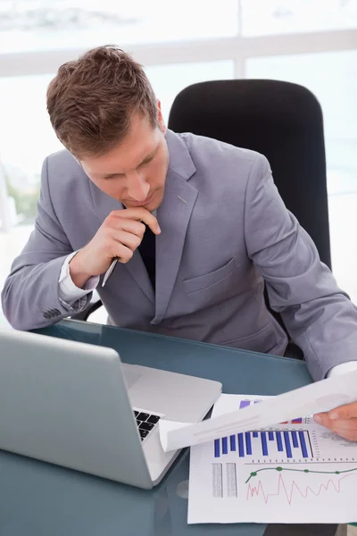 Businessman looking at market research results — Stock Photo, Image