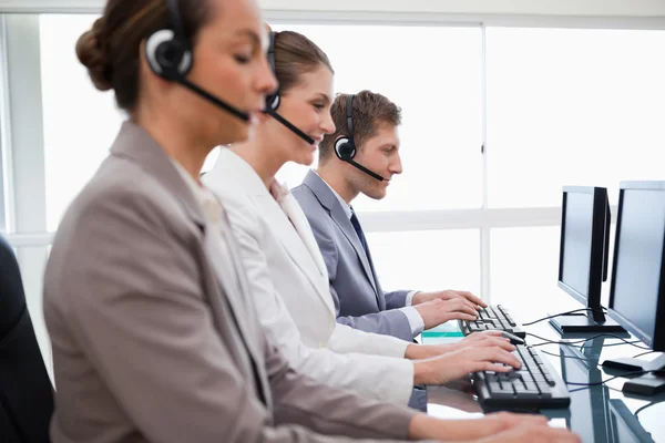 Side view of customer service assistants — Stock Photo, Image