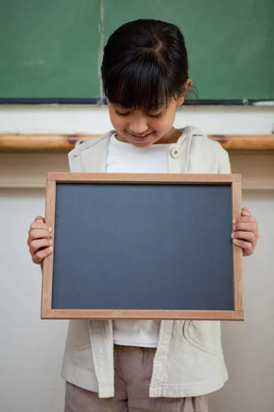 Retrato de uma menina bonito segurando uma ardósia escola — Fotografia de Stock