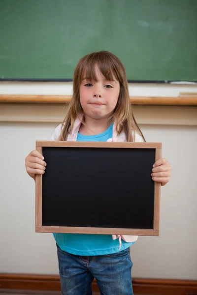 Portrait of a little girl holding a school slate — Stock Photo, Image