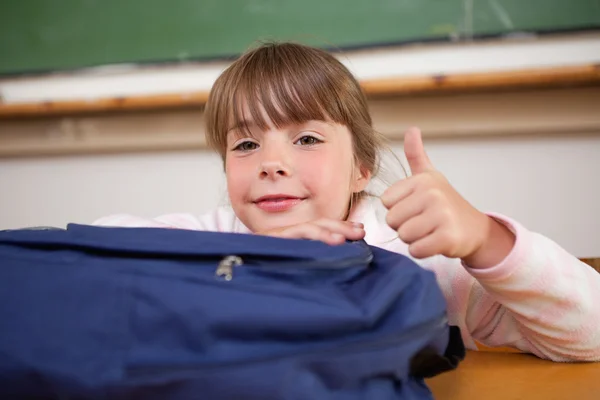 Schoolgirl posing with a bag and the thumb up — Stock Photo, Image