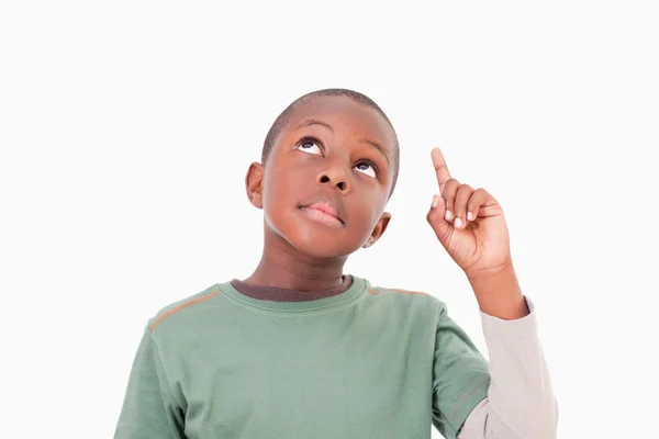 Boy pointing at something above him — Stock Photo, Image