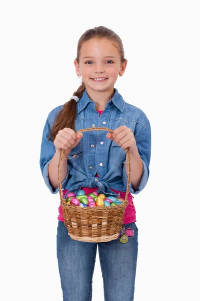 Πορτρέτο ενός κοριτσιού που κρατά ένα καλάθι γεμάτο Πασχαλινά αυγά — Φωτογραφία Αρχείου