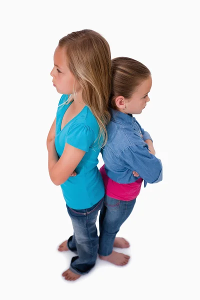 Portrait of girls standing back to back — Stock Photo, Image