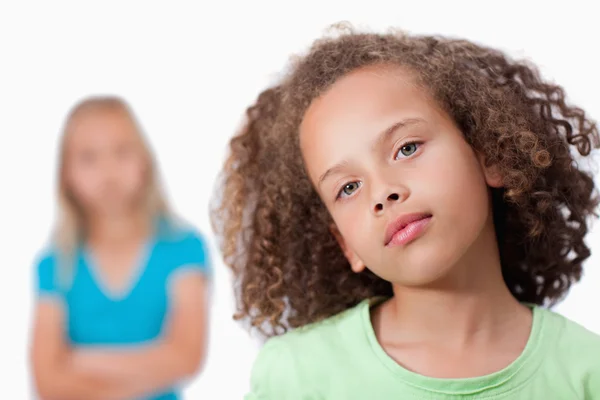 Girl posing with her friend in the background — Stock Photo, Image