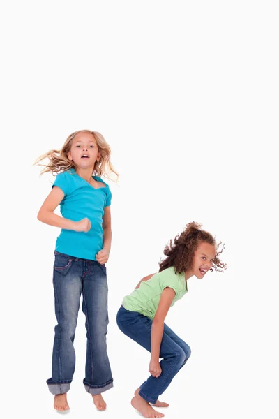 Portrait of happy girls jumping — Stock Photo, Image