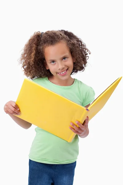 Portrait of a smiling girl reading a fairy tale — Stock Photo, Image