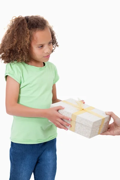 Portrait of a young girl receiving a gift — Stock Photo, Image