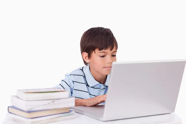 Boy working with a laptop — Stockfoto