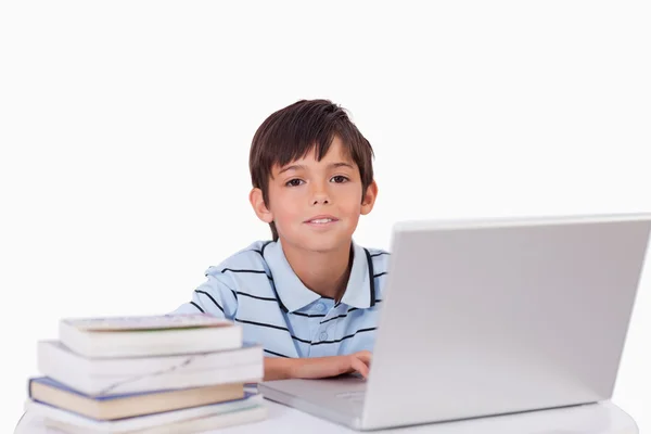 Jongen met een laptop werkt — Stockfoto