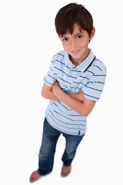 Retrato de um menino sorrindo para a câmera com os braços cruzados — Fotografia de Stock