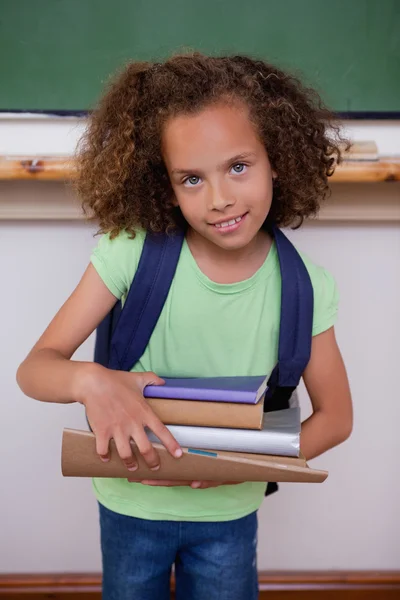 Portrait of a schoolgirl holding books — Stock Photo, Image