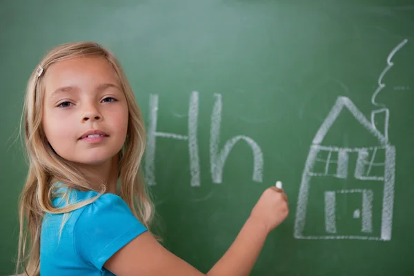 Schoolgirl learning the alphabet — Stock Photo, Image